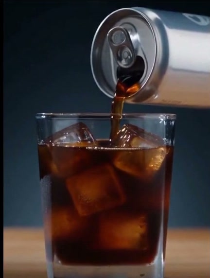 Cold brew pouring into a glass of ice, one shot from the ad